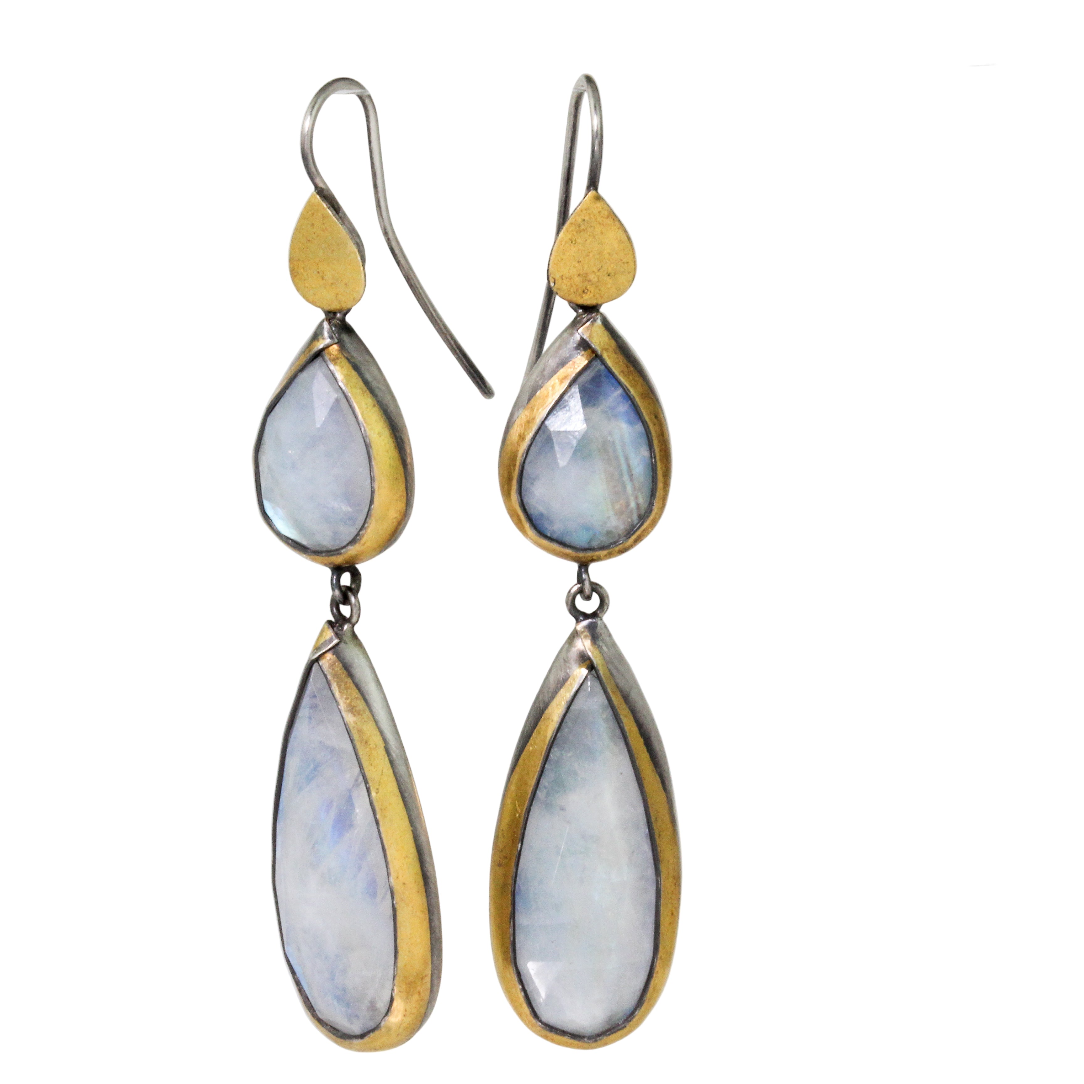 Pair of earrings with teardrop-shaped gemstones on a white background