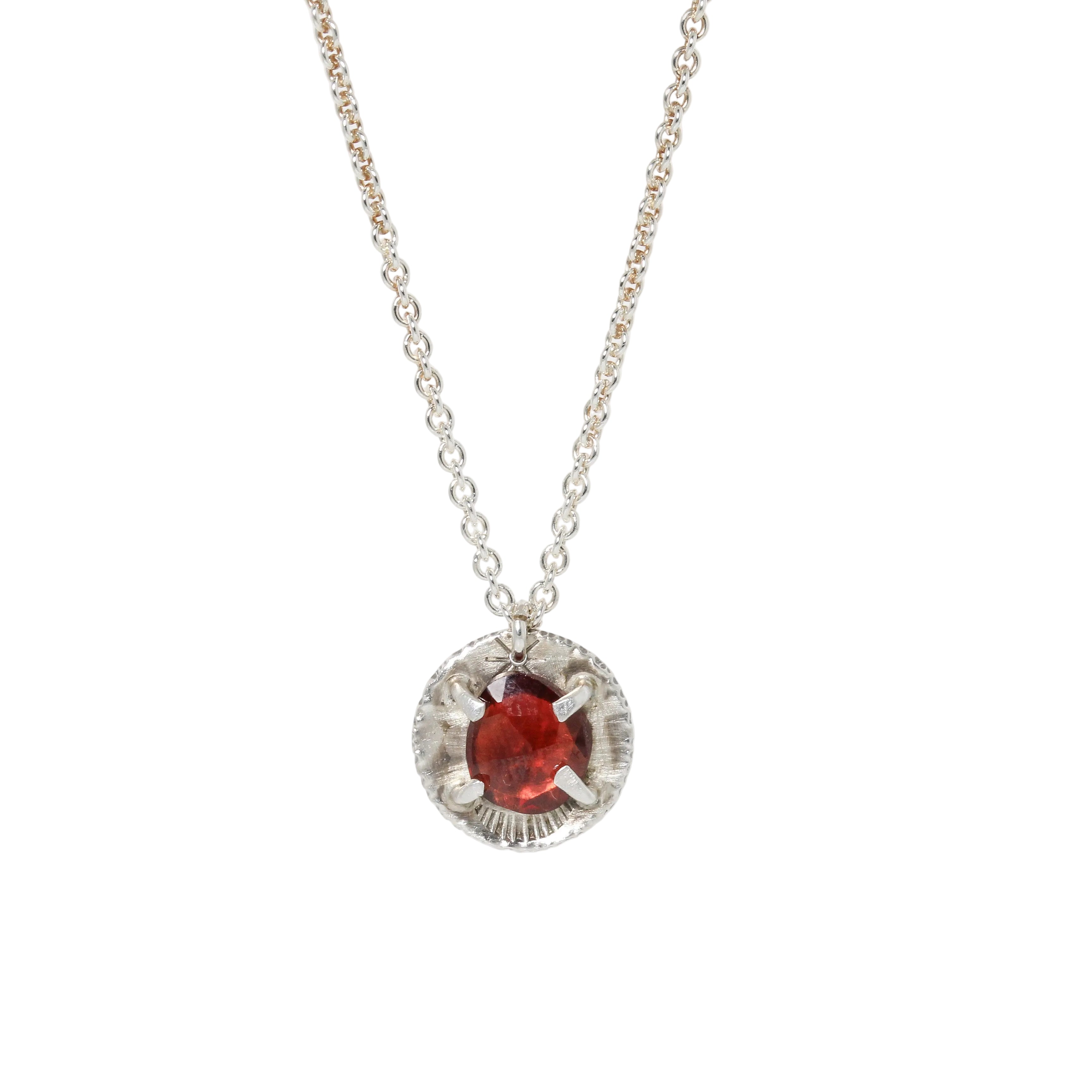 Silver necklace with garnet pendant by glacier lily