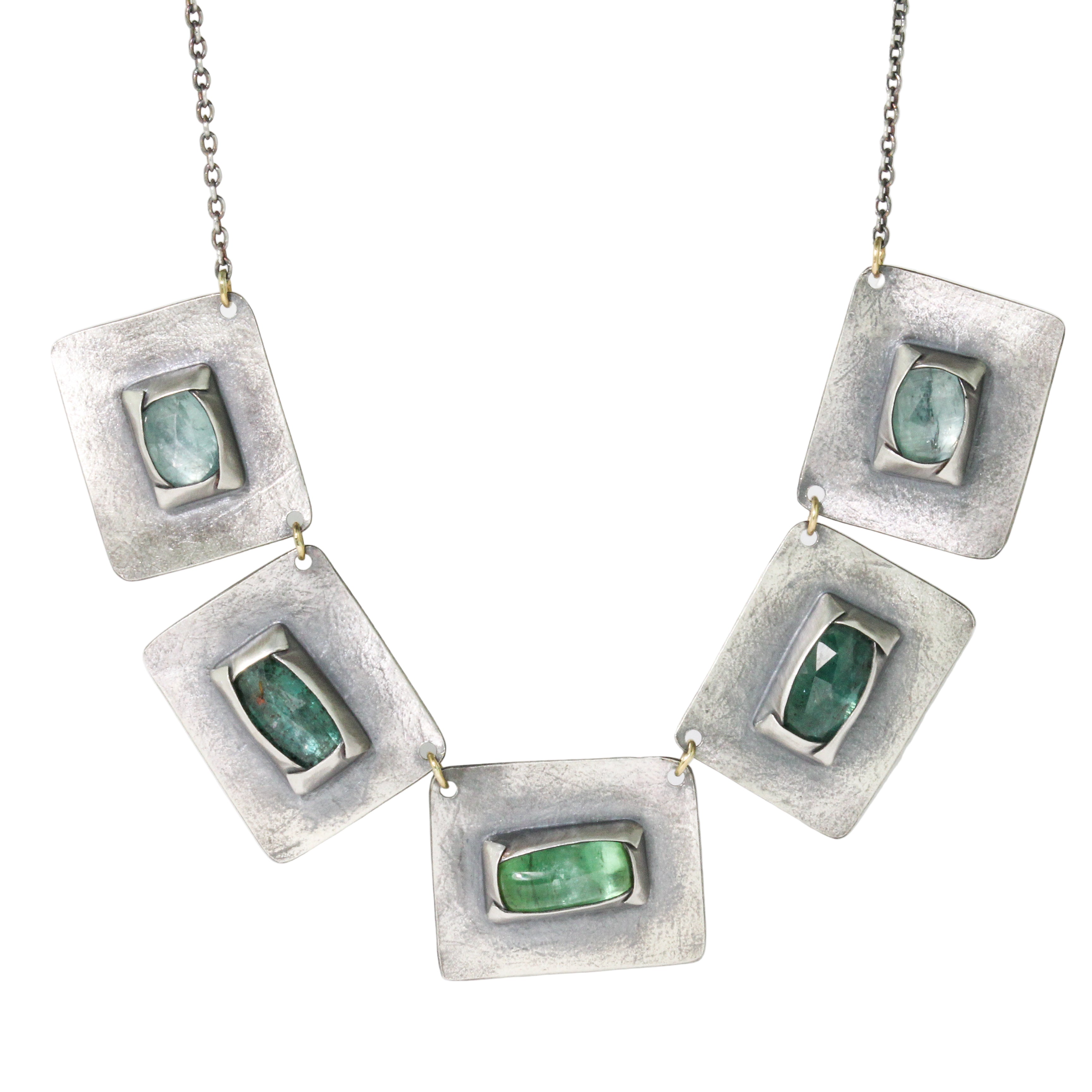 Necklace with square pendants featuring green gemstones on a white background
