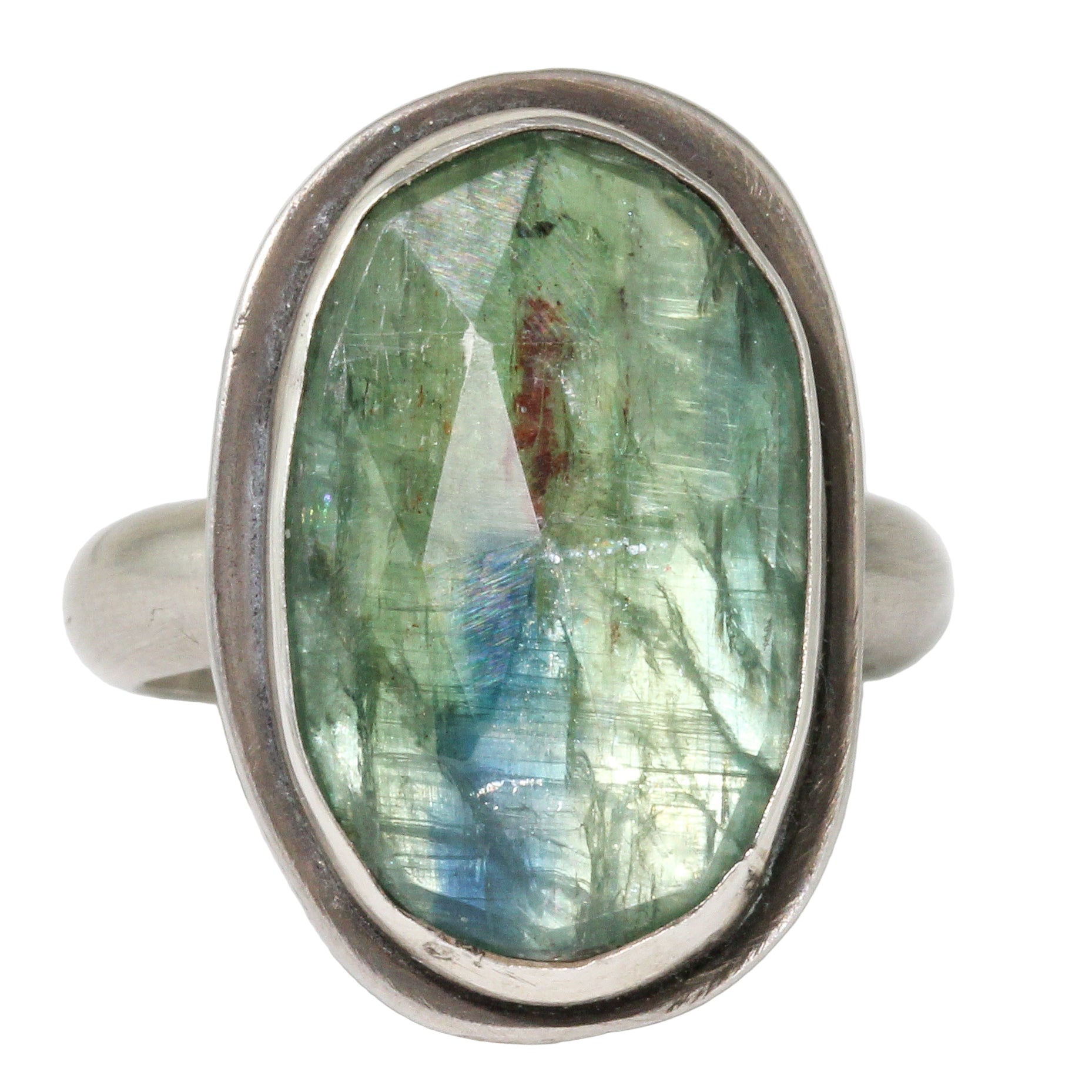 Silver ring with a green gemstone on a white background