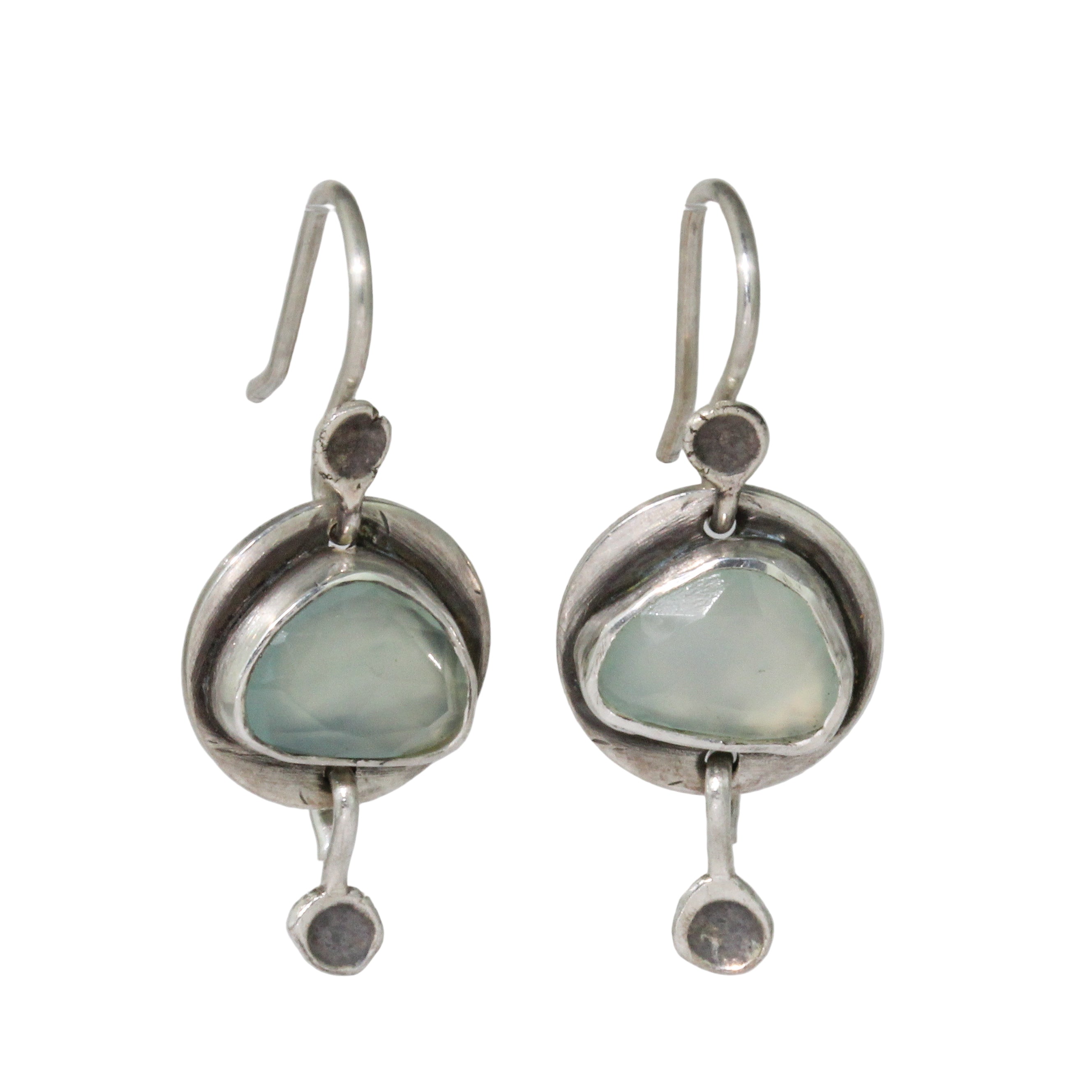 Silver earrings with green gemstones on a white background