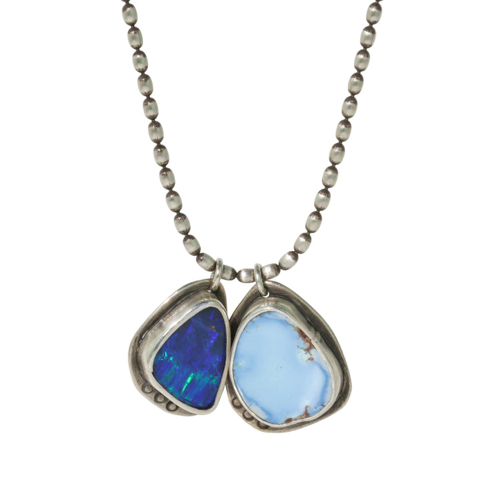 Necklace with two colorful stones in silver settings on a white background
