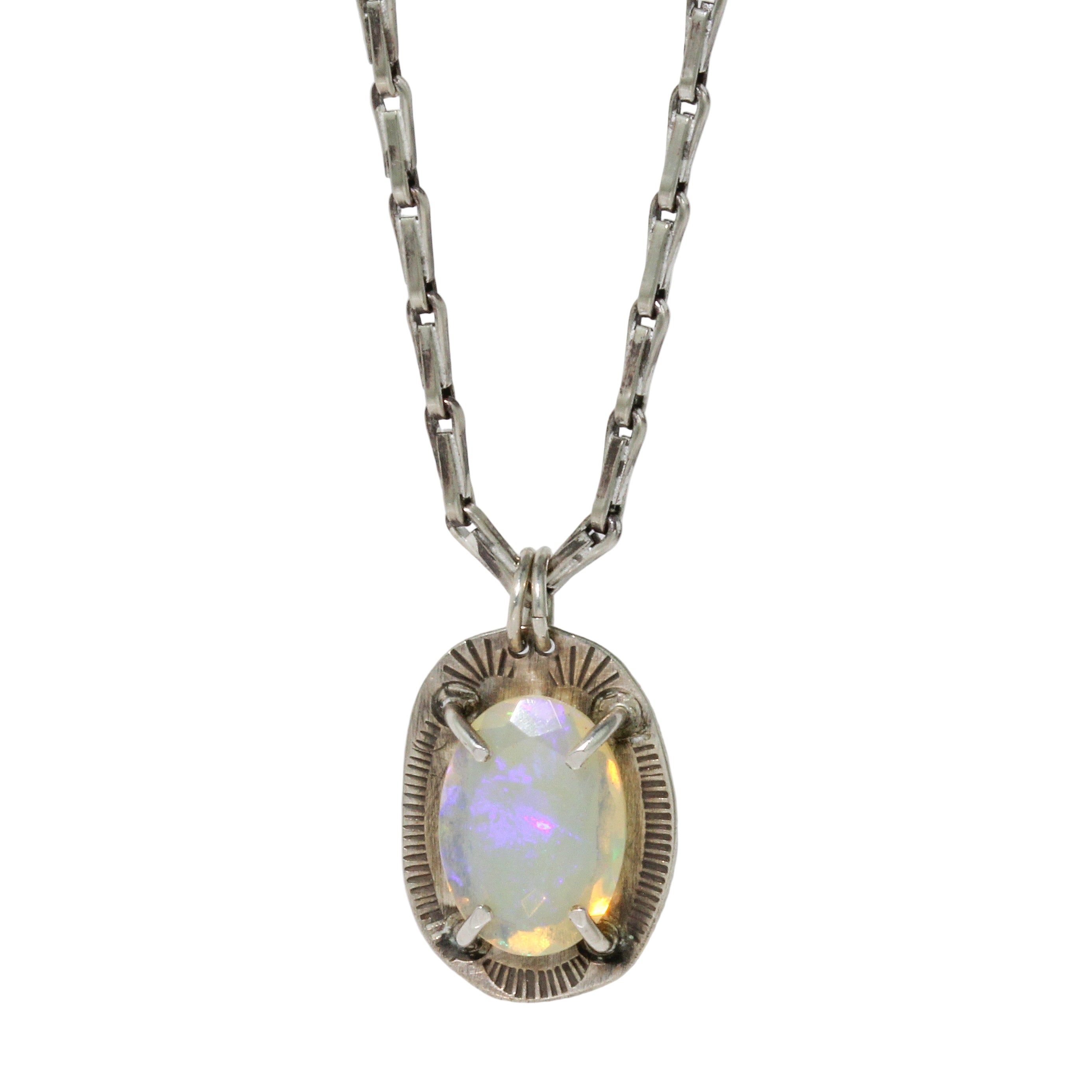 Necklace with an opal pendant on a light gray background