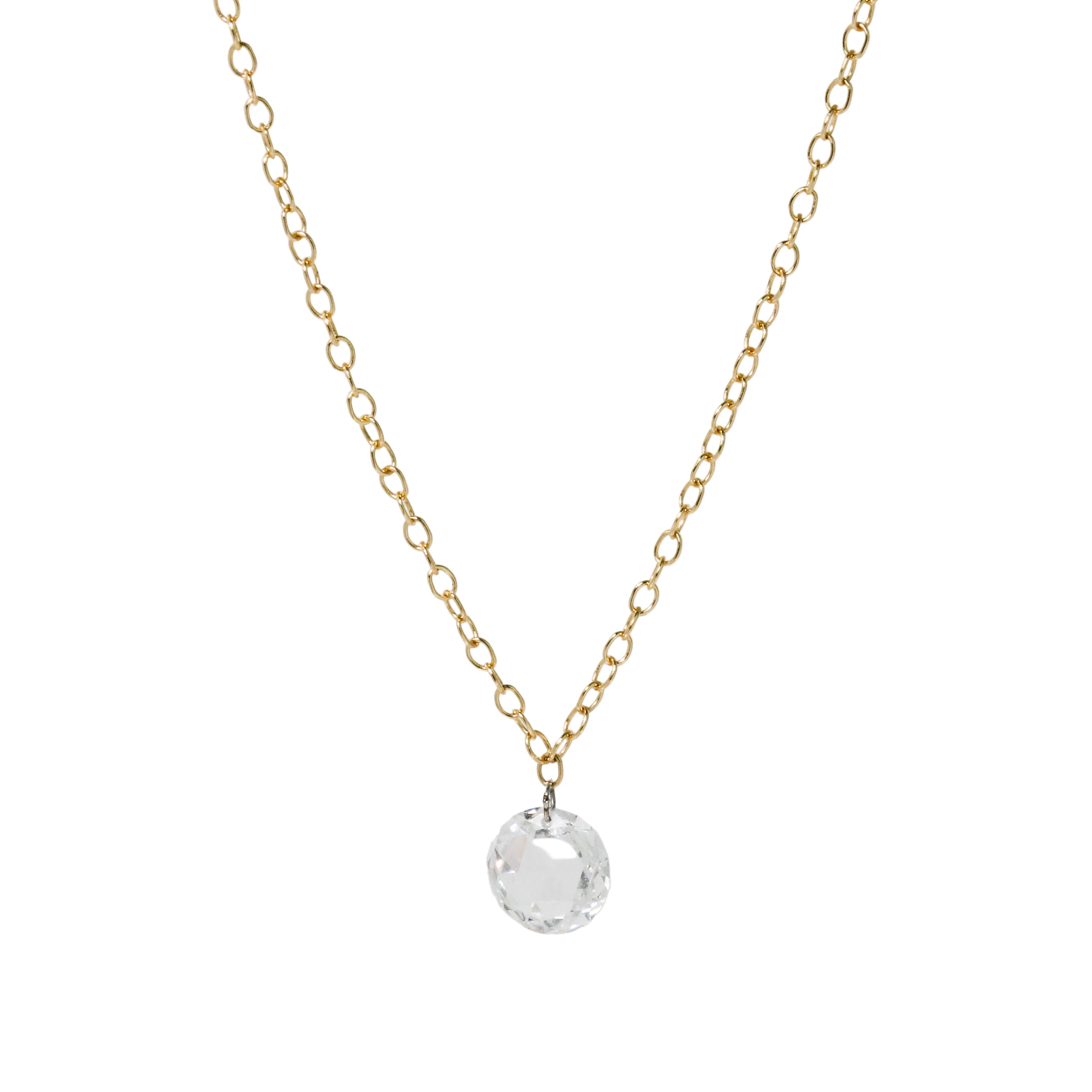 Gold necklace with a clear diamond pendant on white background