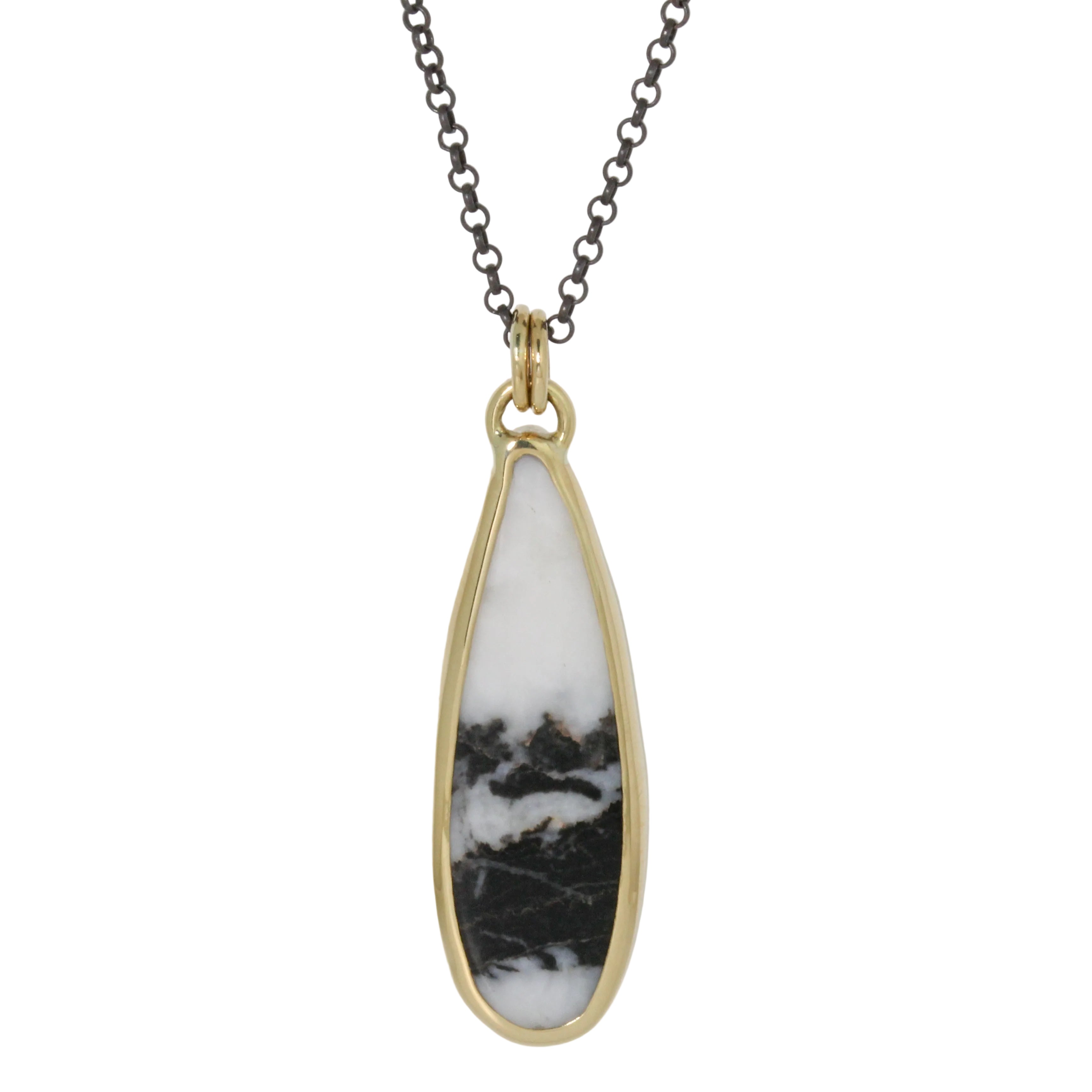 Necklace with a teardrop-shaped pendant featuring black and white marbled design on a light gray background.