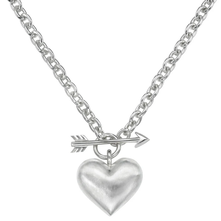 Silver necklace with a heart pendant and arrow charm on a white background
