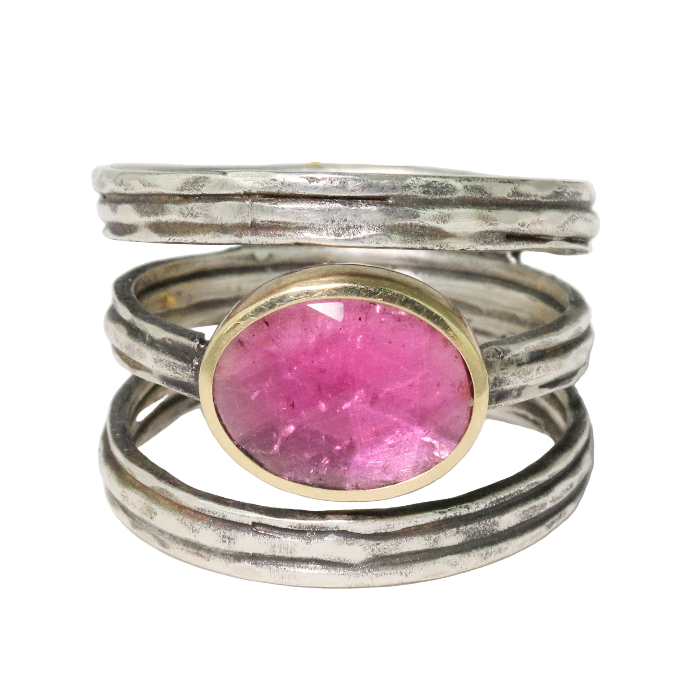 Silver and gold ring with a pink gemstone on a white background