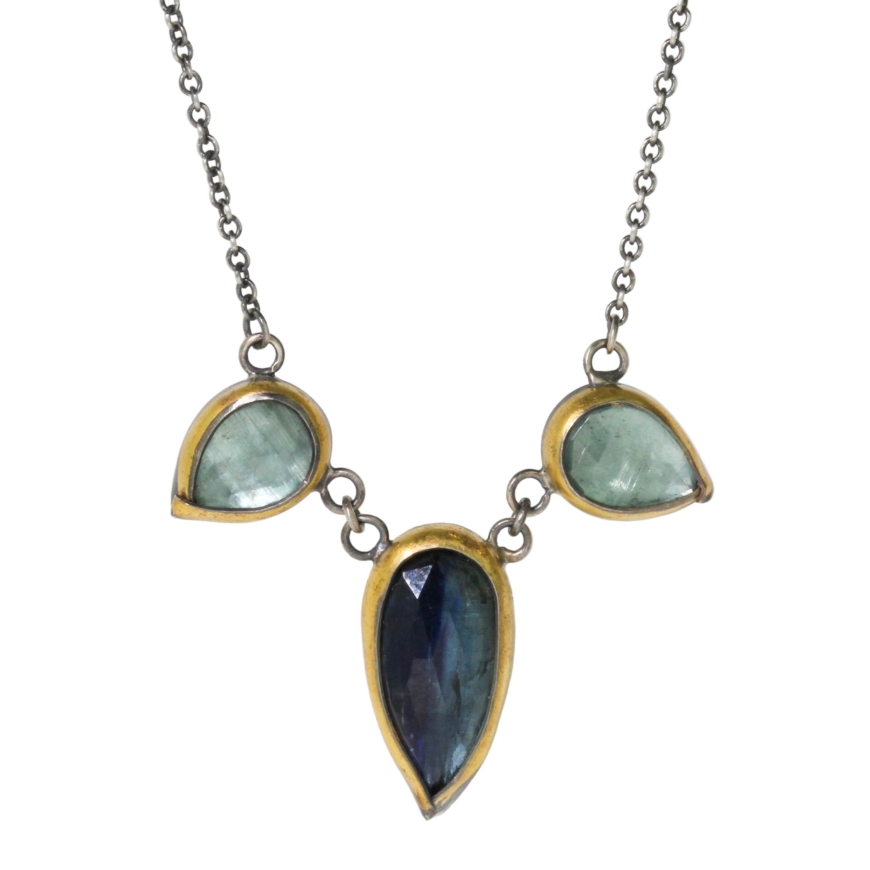 Necklace with teardrop-shaped gemstones on a white background