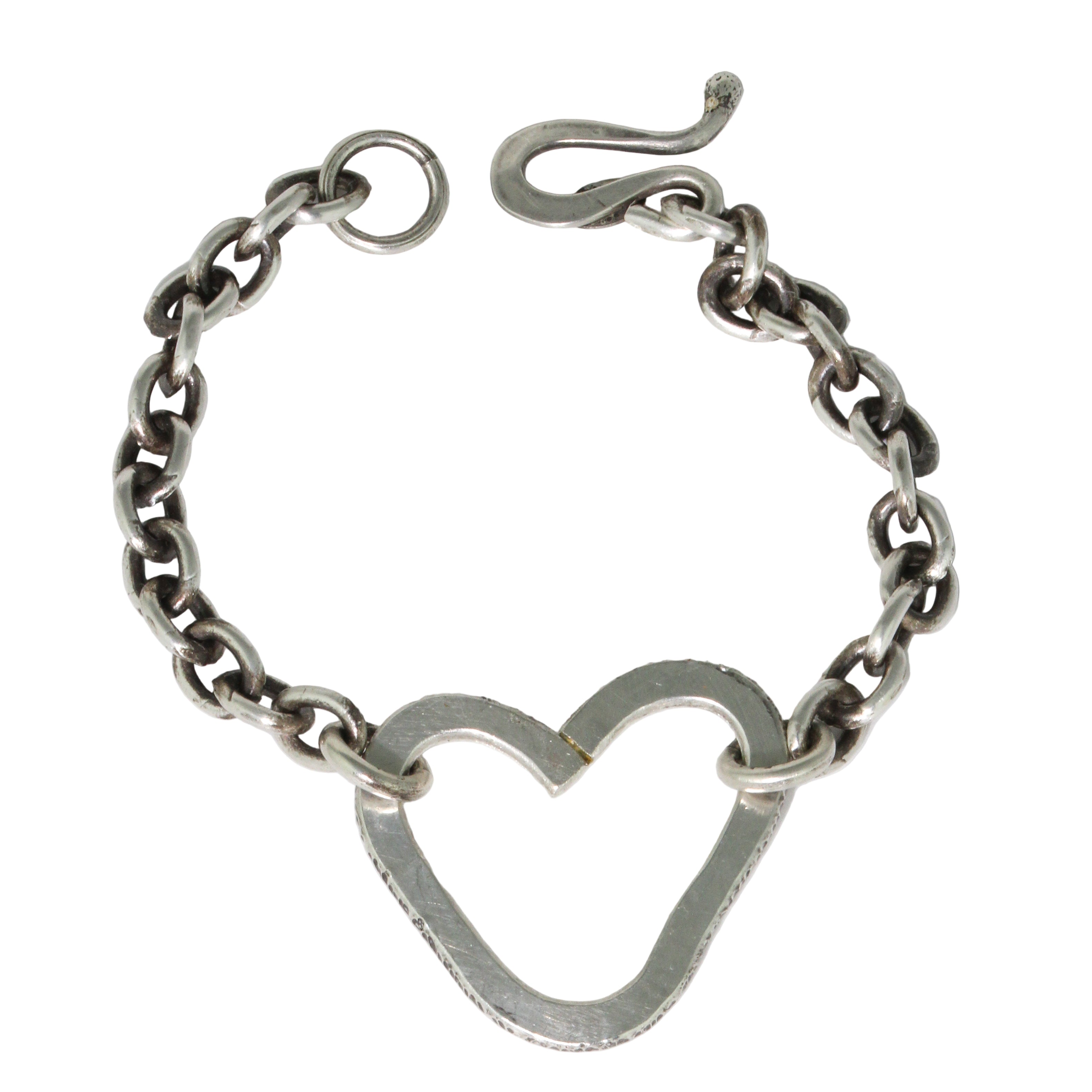 Silver chain bracelet with a heart-shaped clasp on a white background